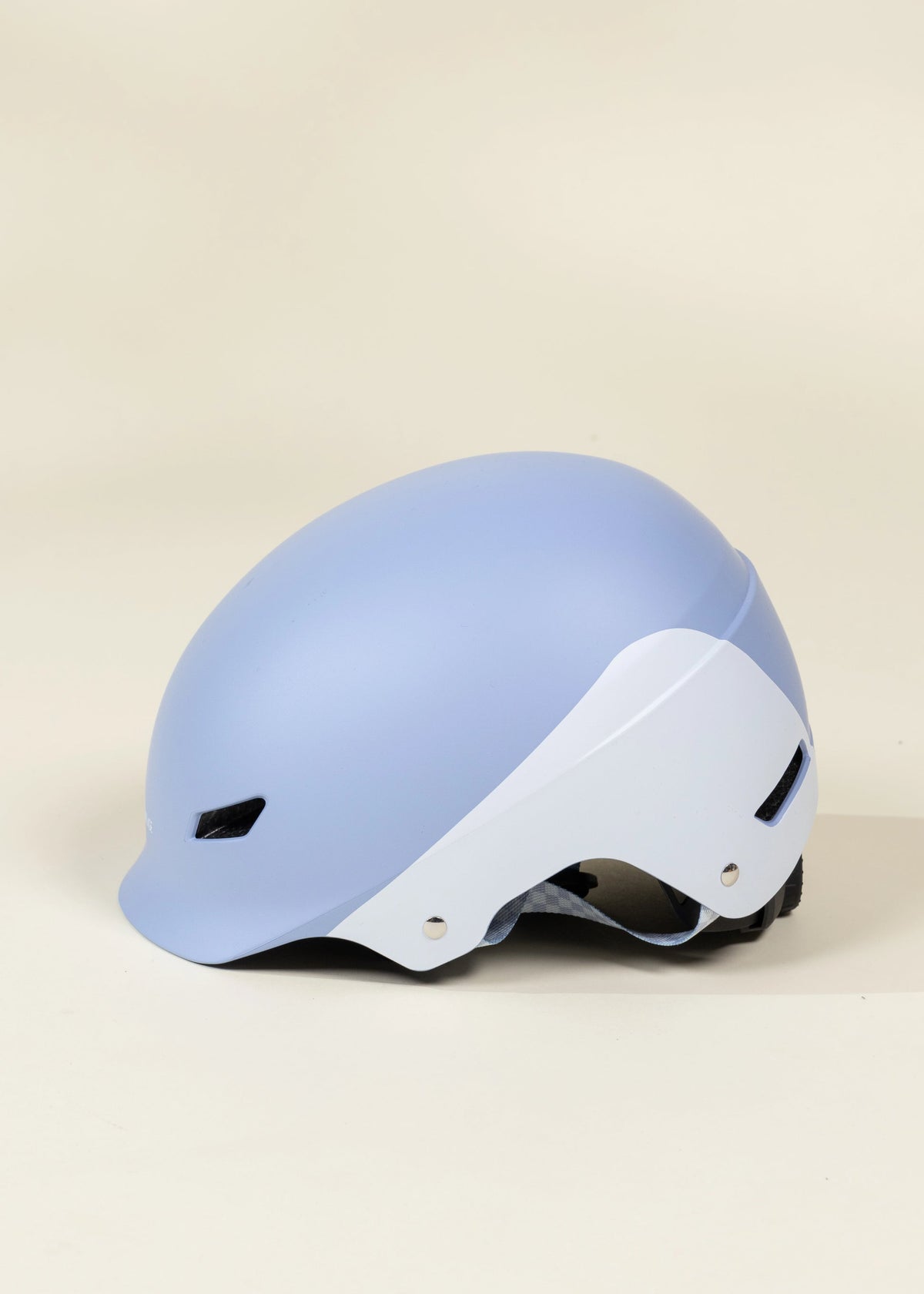 Light blue and white helmet on a beige background