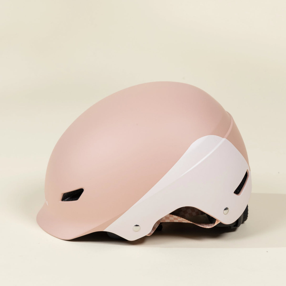 Pink helmet with white visor on a beige background