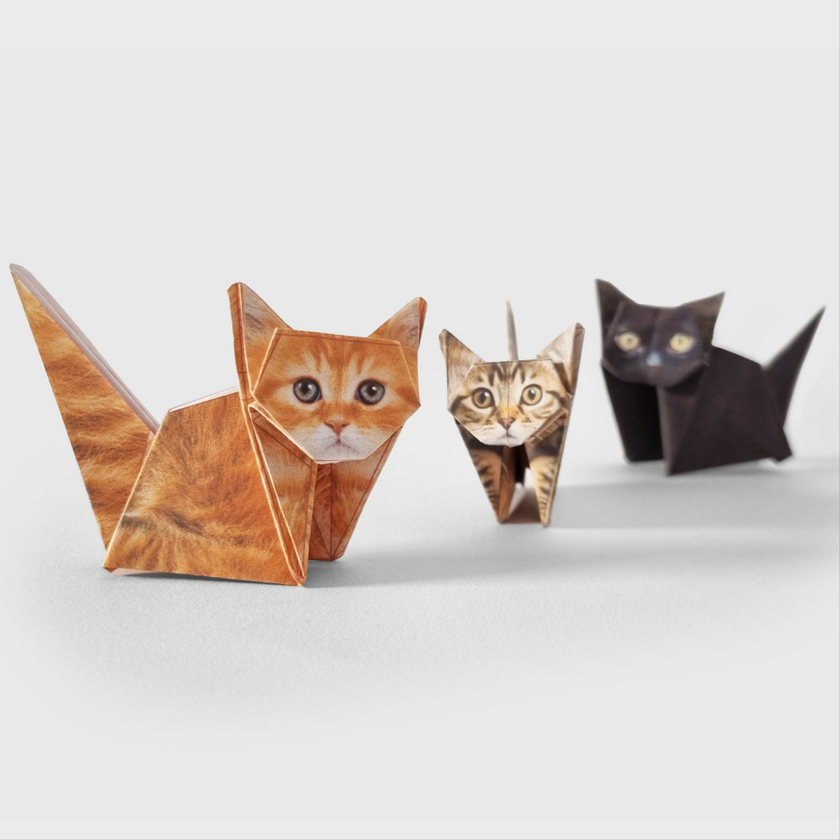 Three origami cats with cat faces on a white background