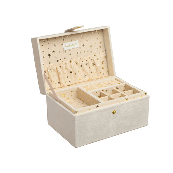 An open jewelry box in a light beige velvet-like material with a gold star pattern on the interior lining. The box has multiple compartments, a ring roll on the inside lid, and a small wooden stick inside.