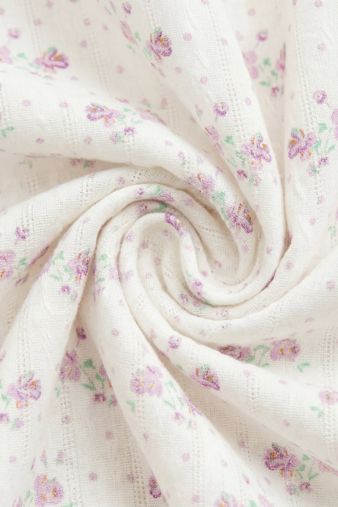 Floral patterned fabric with small flowers on a white background