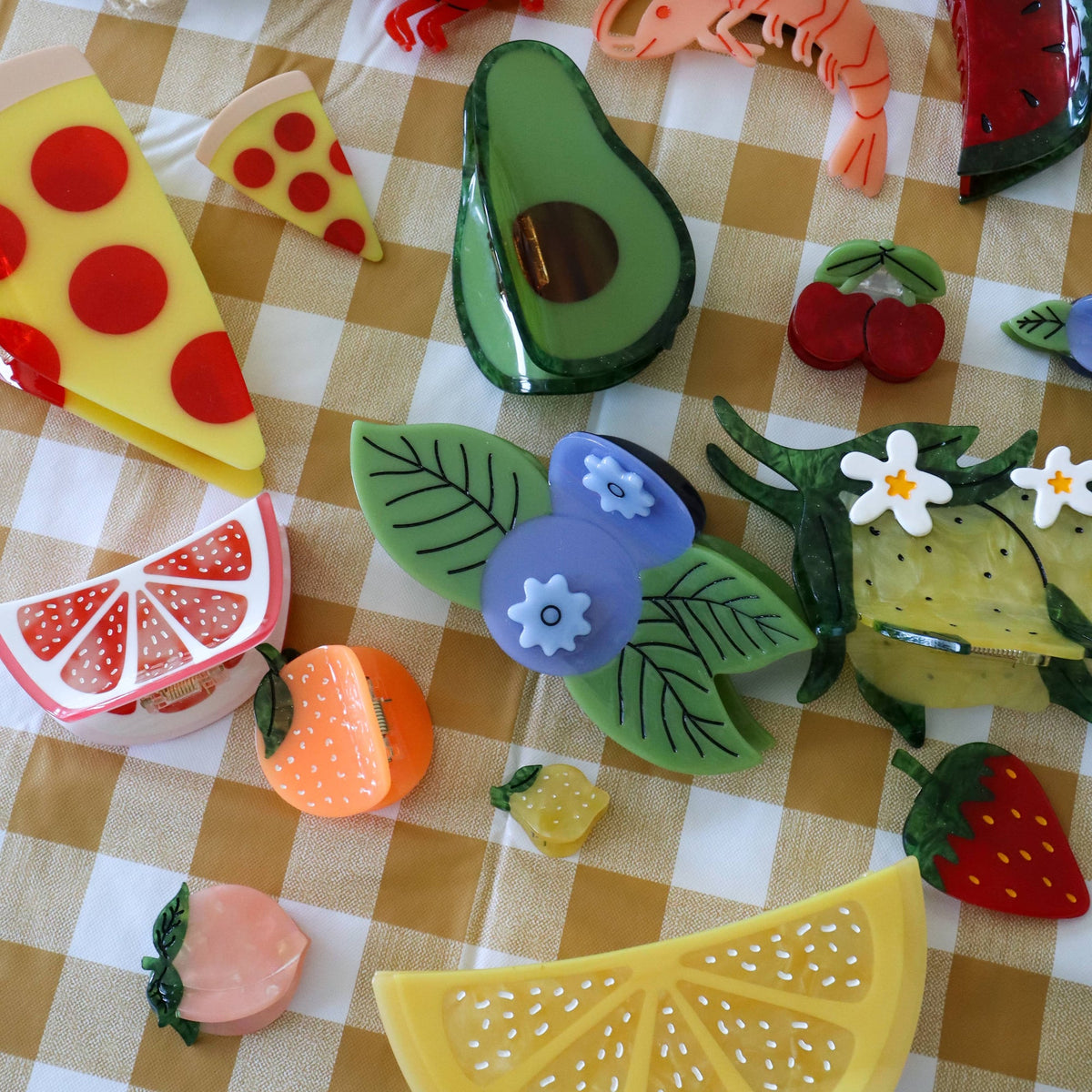 Colorful plastic food toys on a checkered tablecloth