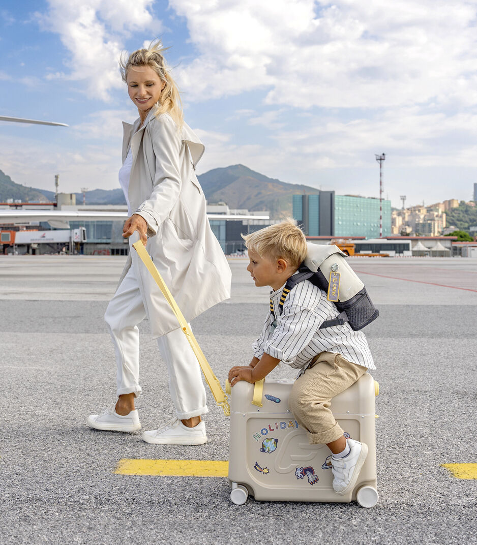 Woman and child with a suitcase at an airport