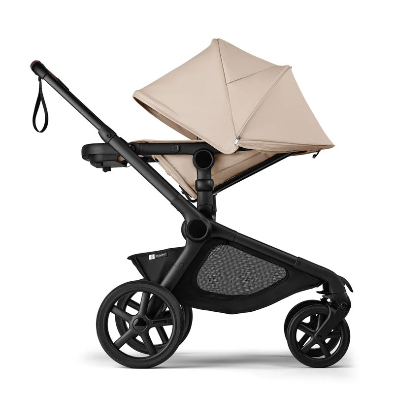 Black stroller with beige canopy on a white background
