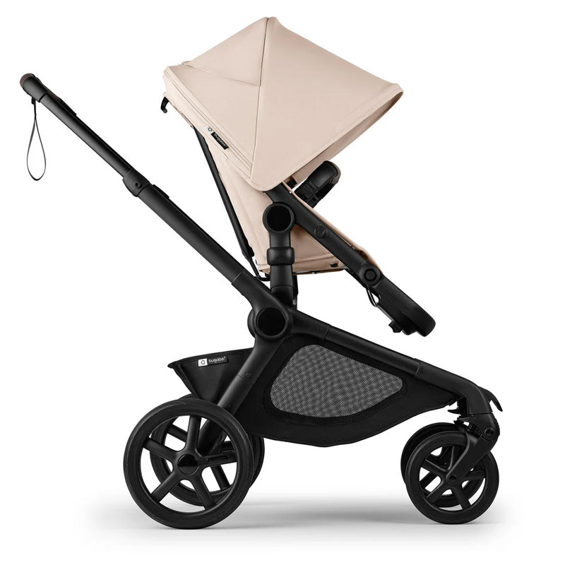 Beige and black stroller on a white background