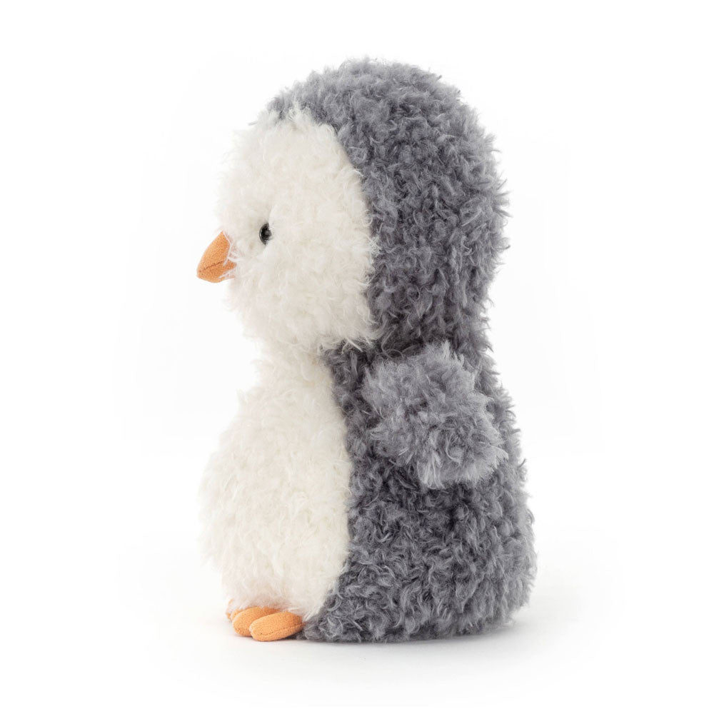 Stuffed penguin toy with gray body and white belly on a white background