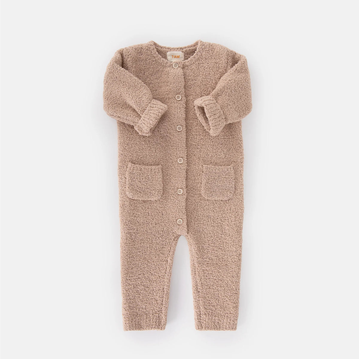 A soft, long-sleeve fuzzy romper in a warm pecan brown color by 7AM Enfant, featuring a round neckline, a full-length center button closure, ribbed cuffs and ankles, and two front pockets, laid flat on a white background.