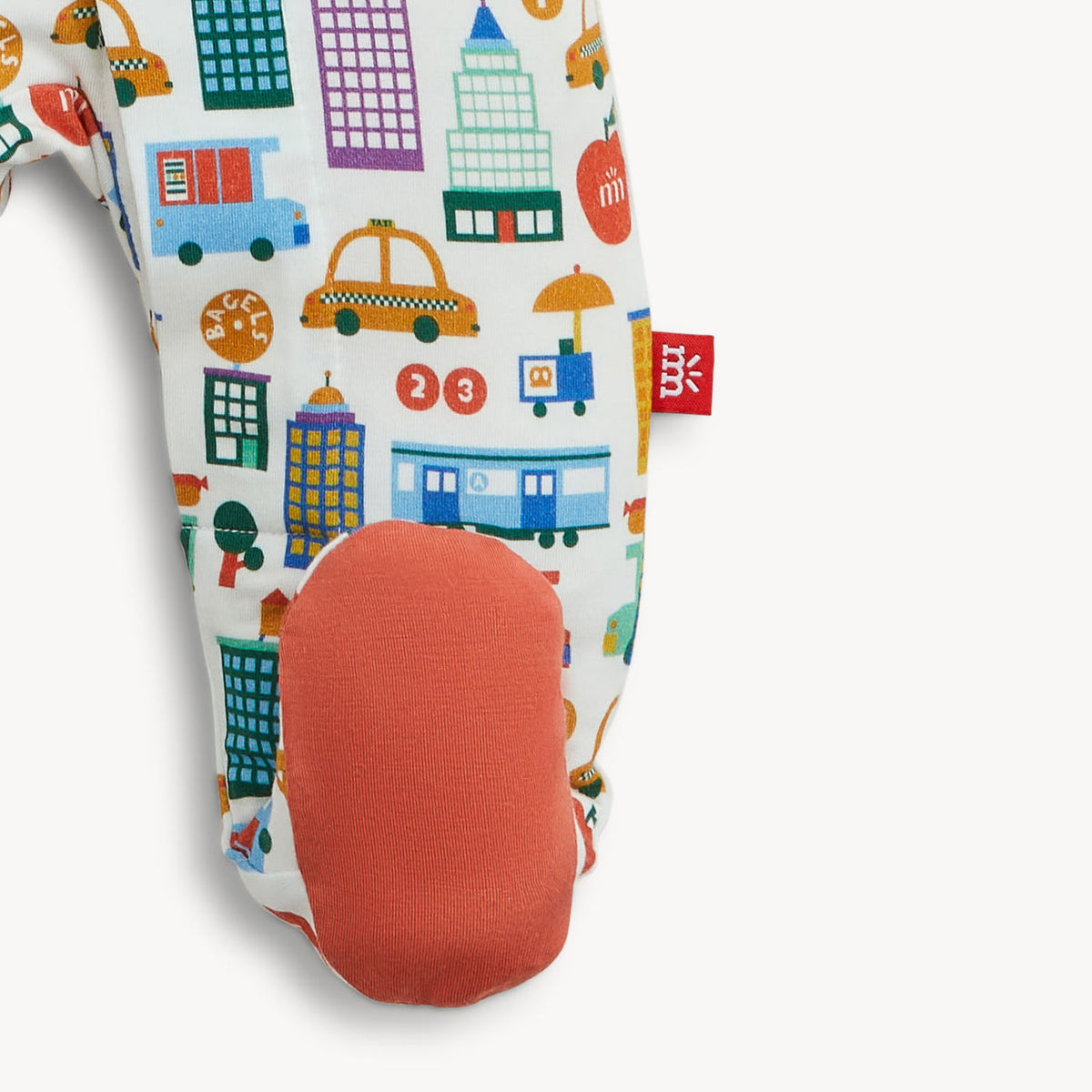 Colorful children's socks with cityscape pattern and red sole on a white background