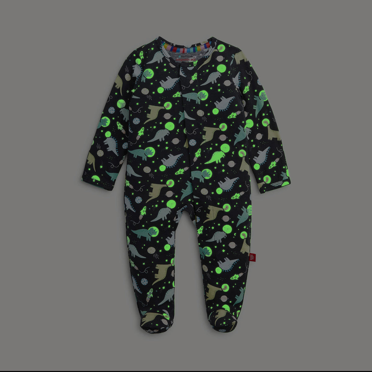 Children's onesie with dinosaur pattern on a gray background