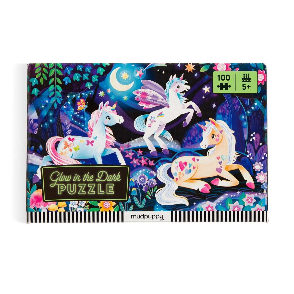 Completed Unicorn Dreams 100 Piece Glow in the Dark Puzzle by Mudpuppy laid out flat, displaying a colorful nighttime fantasy scene with three unicorns, a crescent moon, and flowers.