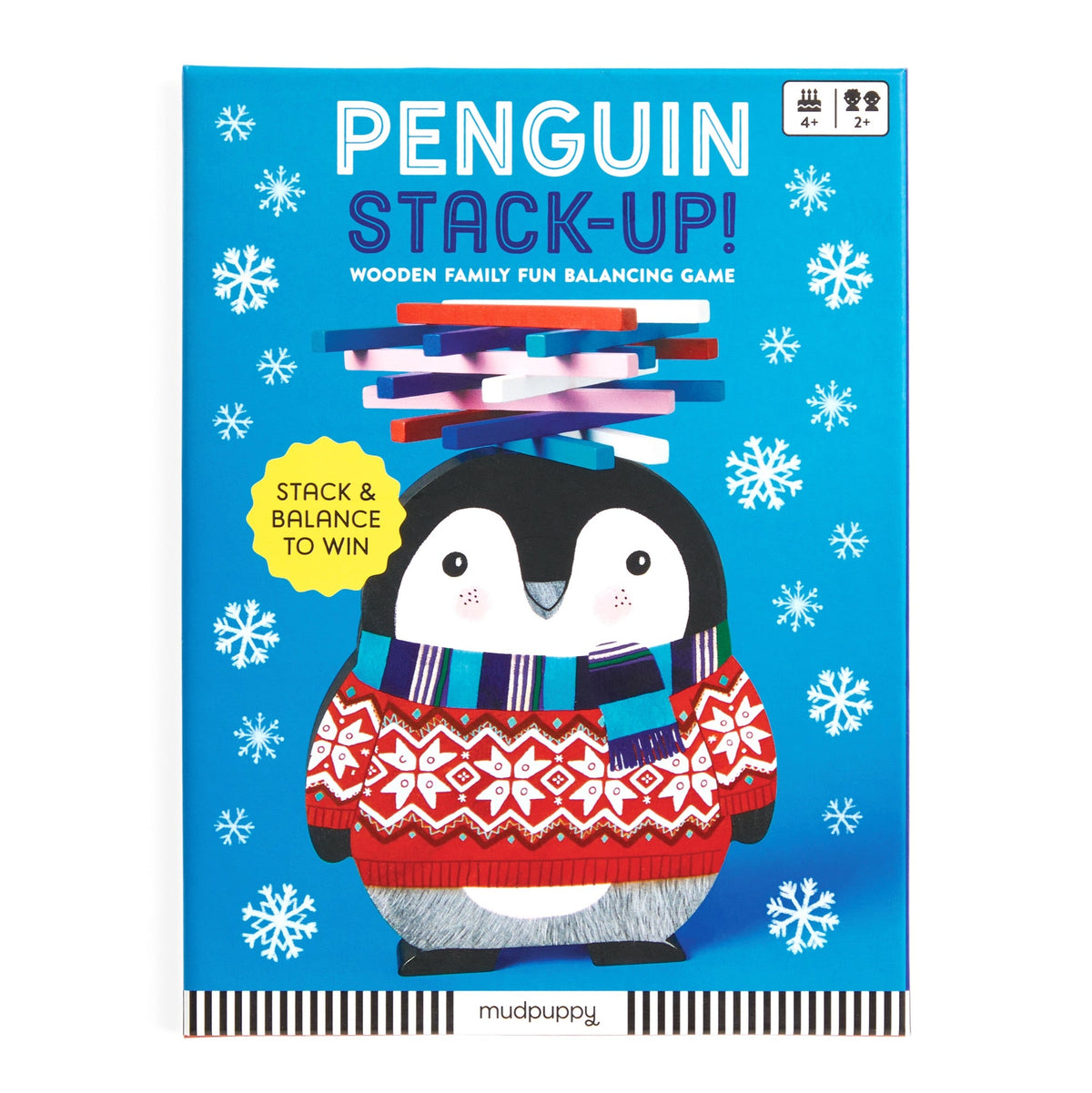 Product box for the Penguin Stack-up Wooden Balancing Game by Mudpuppy featuring a smiling, illustrated penguin wearing a red patterned winter sweater against a vibrant blue, snowy background with white snowflakes.