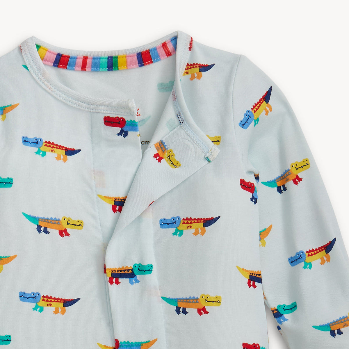 Children's outfit with colorful alligator pattern on a white background