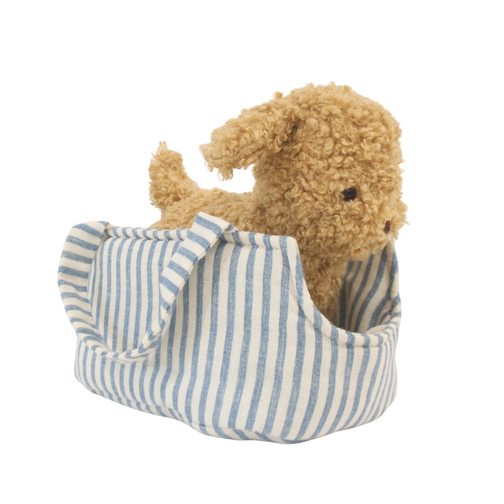 Plush teddy bear in a blue and white striped bag on a white background
