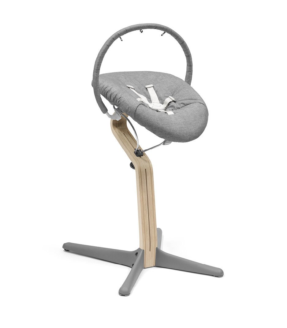 Gray baby swing with wooden stand on a white background