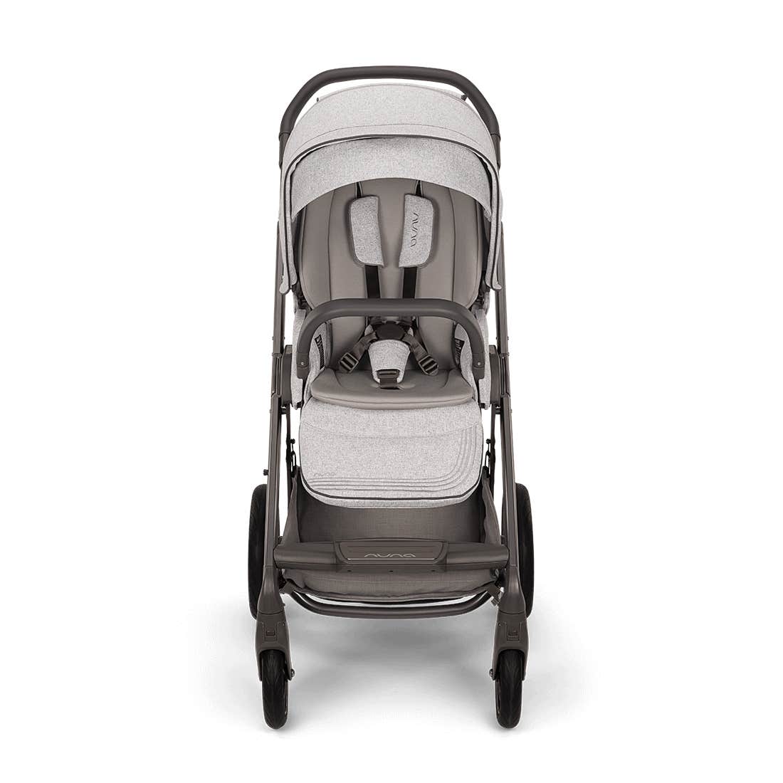 A stroller with a light gray and taupe-gray color scheme, featuring a textured fabric canopy, seat pad, and matching footmuff, set against a plain white background.