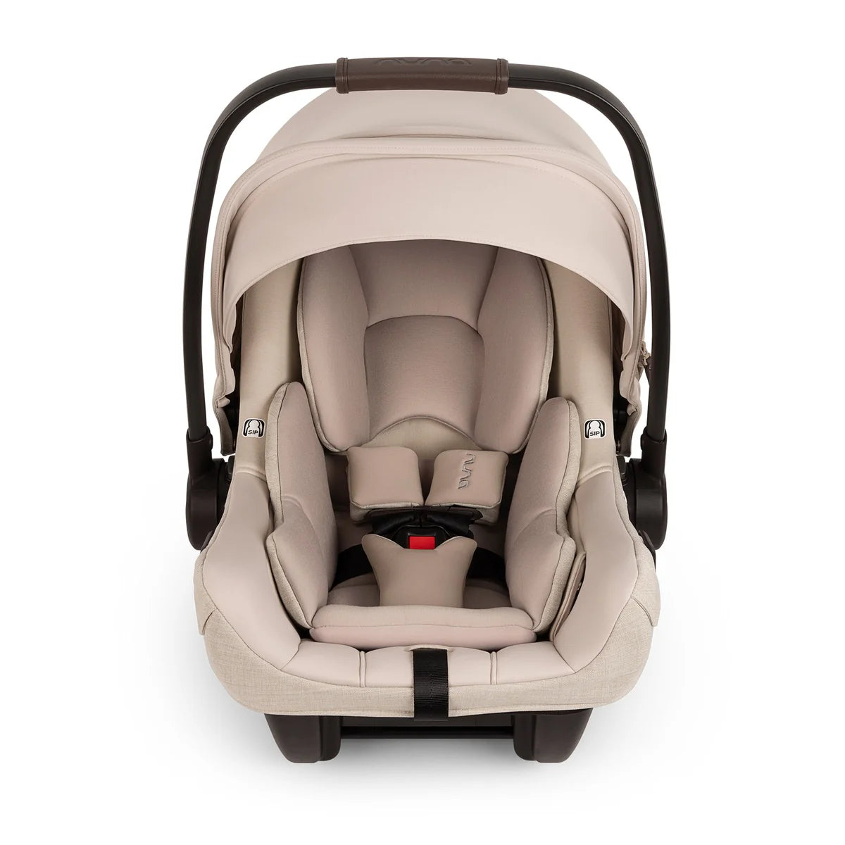 A front view of a MIXX Next + Pipa Aire RX Travel System by Nuna infant car seat in Biscotti featuring a beige seat with matching head and body inserts, a brown leatherette carry handle, and safety harness straps with magnetic buckle holders, set against a clean white background.