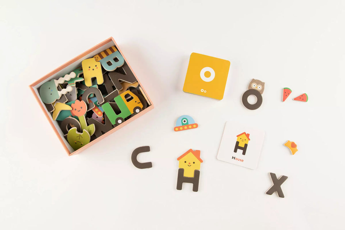 Wooden alphabet letters and shapes on a white background