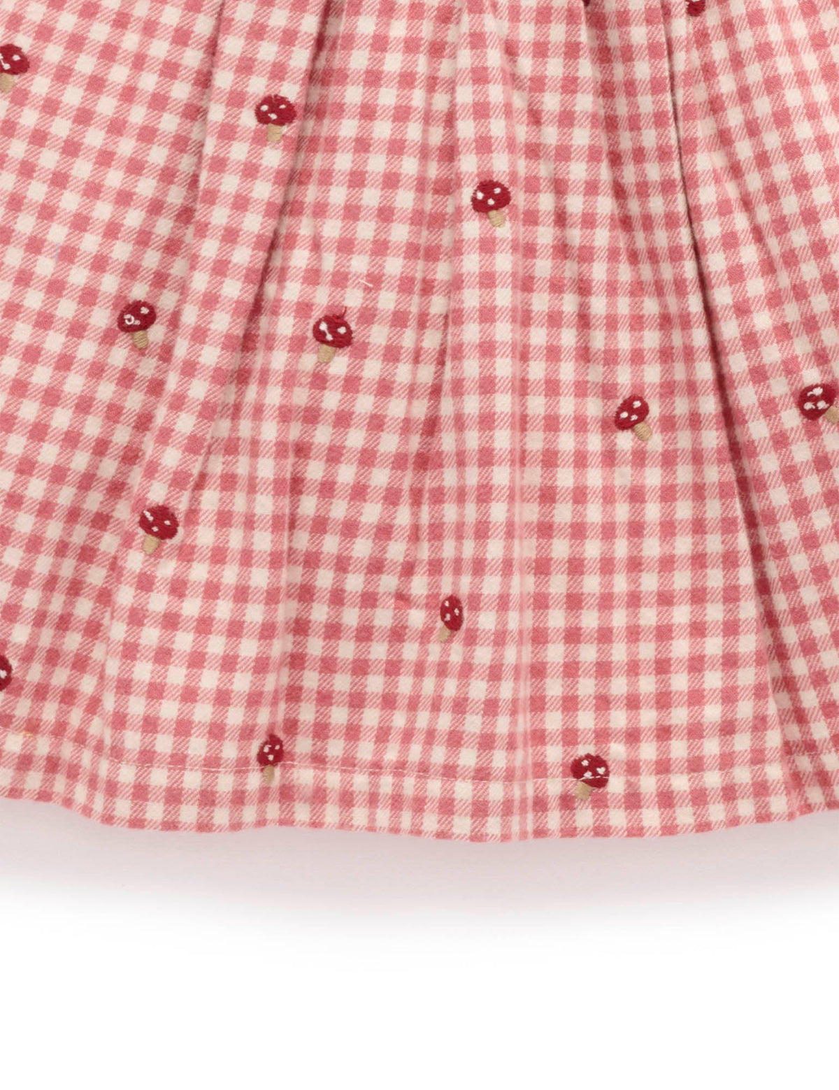 Red and white checkered fabric with small red flower patterns on a white background