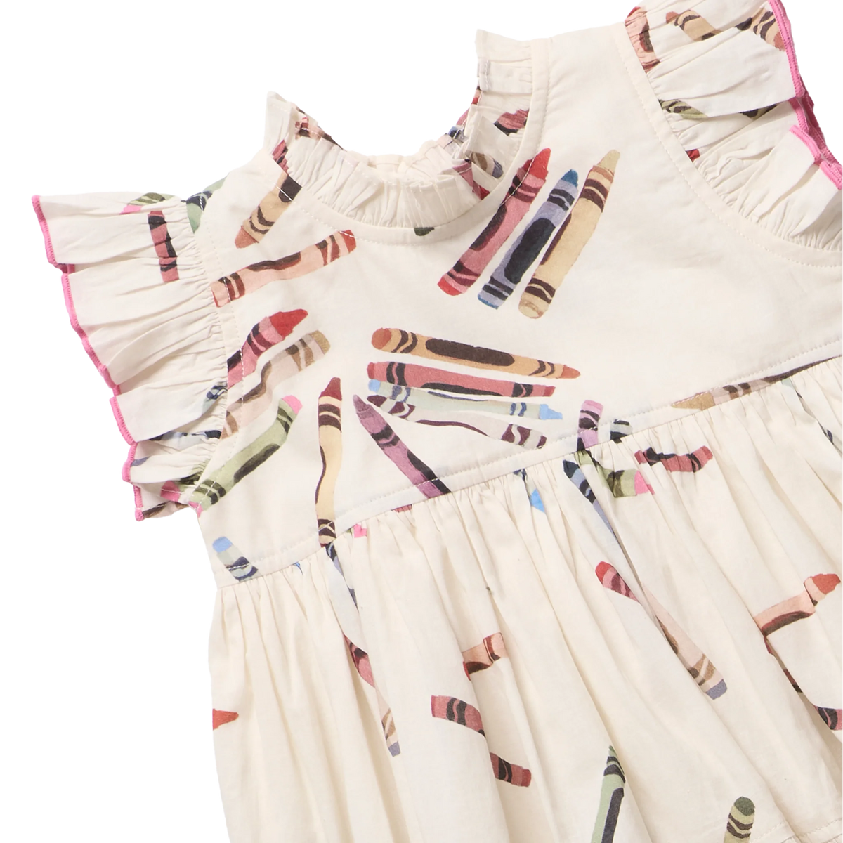Close-up of a cream-colored children's dress with a colorful crayon print.