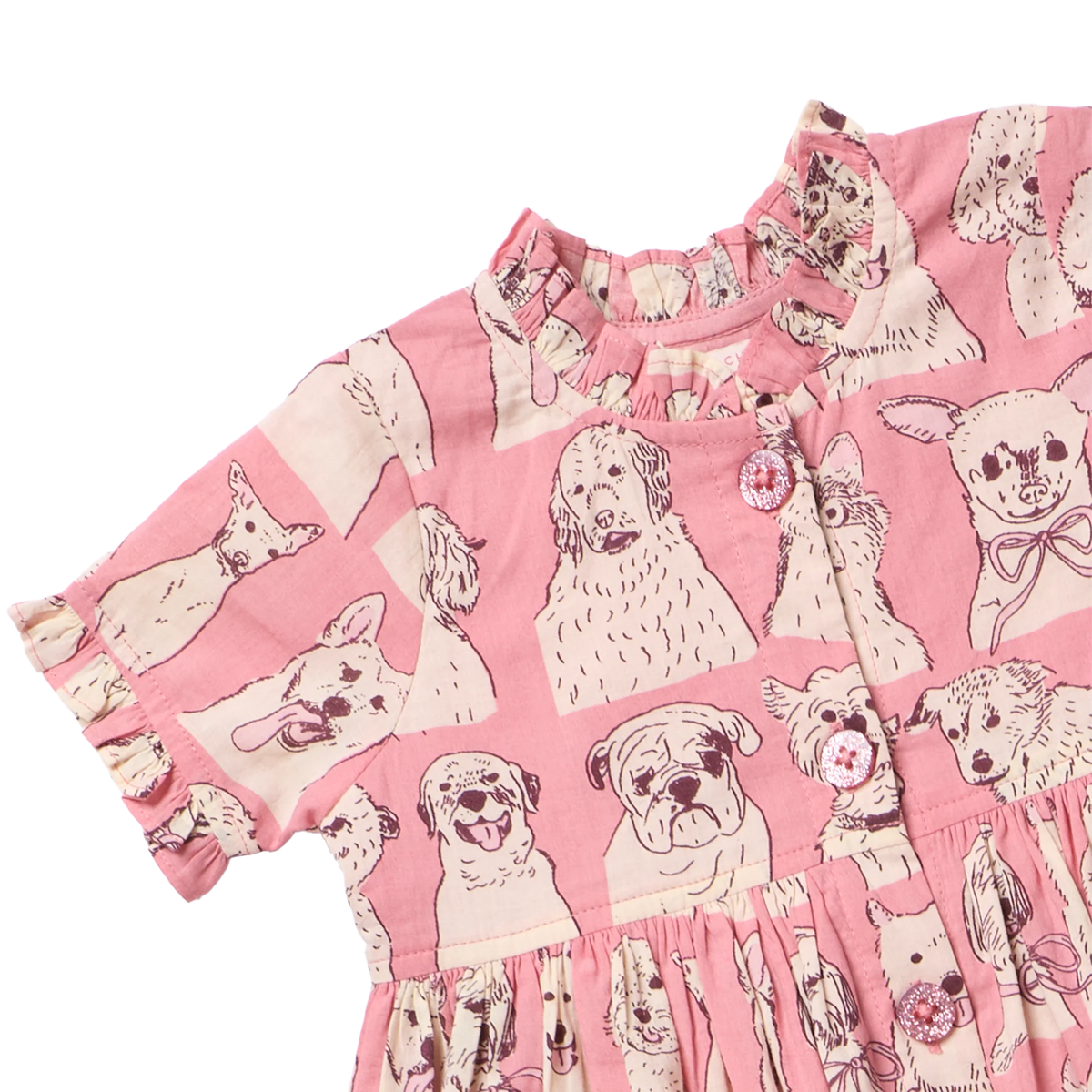 Pink short-sleeve dress with a dog print pattern, featuring illustrations of various dog breeds in cream and brown on a pink background.