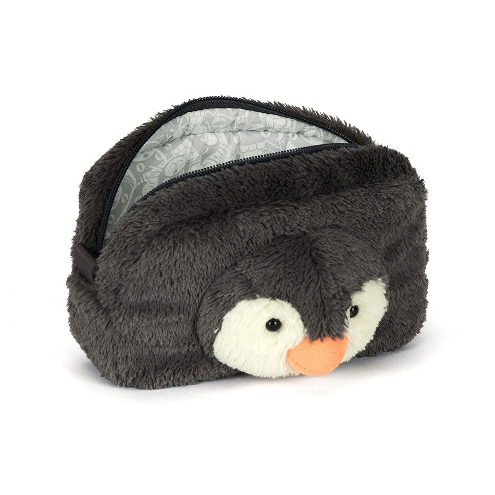 Plush penguin-shaped eye mask on a white background