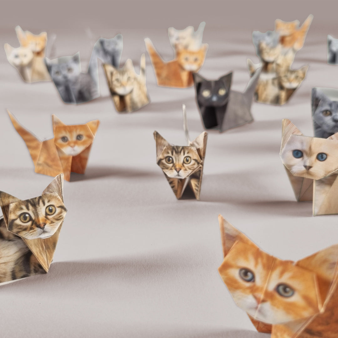Origami cats of various colors arranged on a beige surface