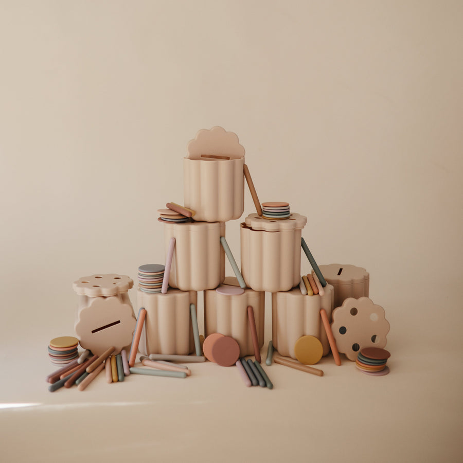 Stack of wooden toys on a beige background