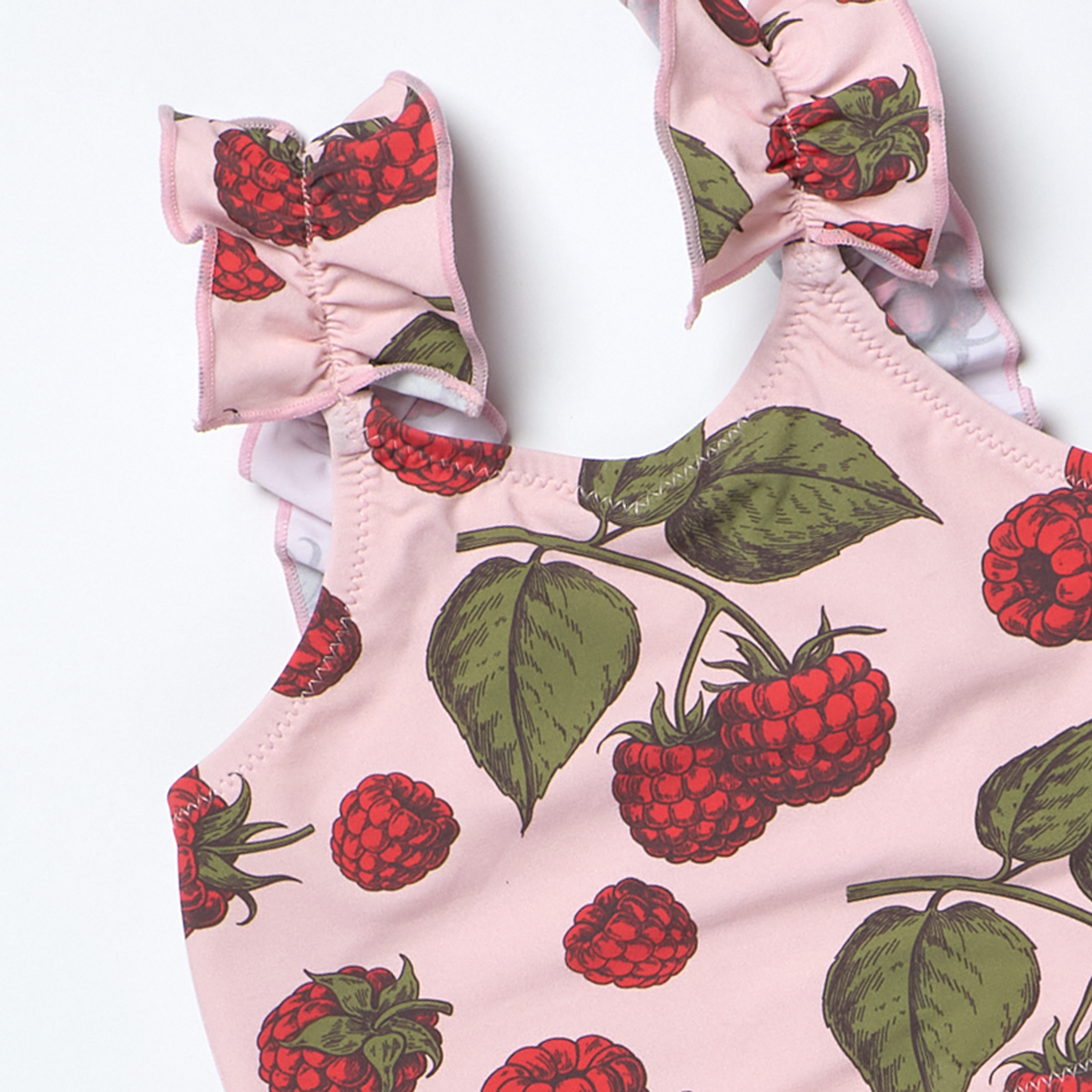 Pink children's outfit with raspberry pattern on a white background