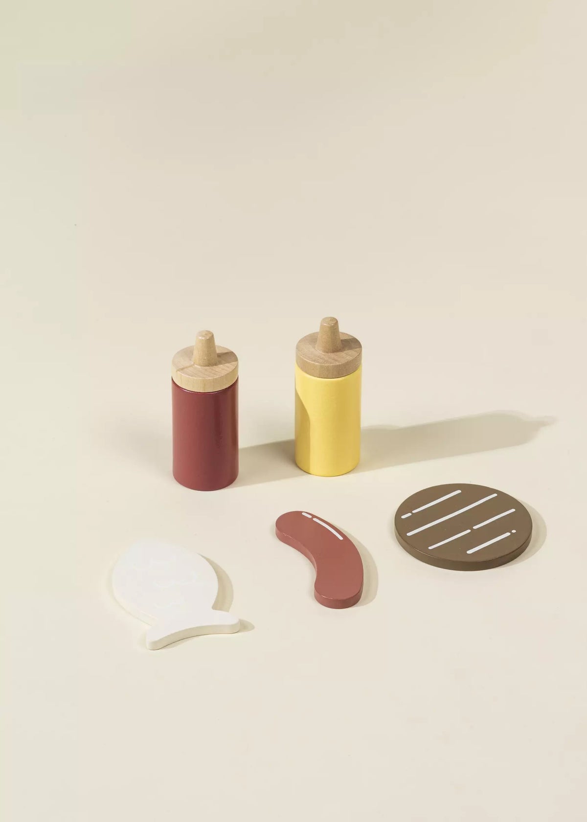 Wooden condiment bottles with a beige background