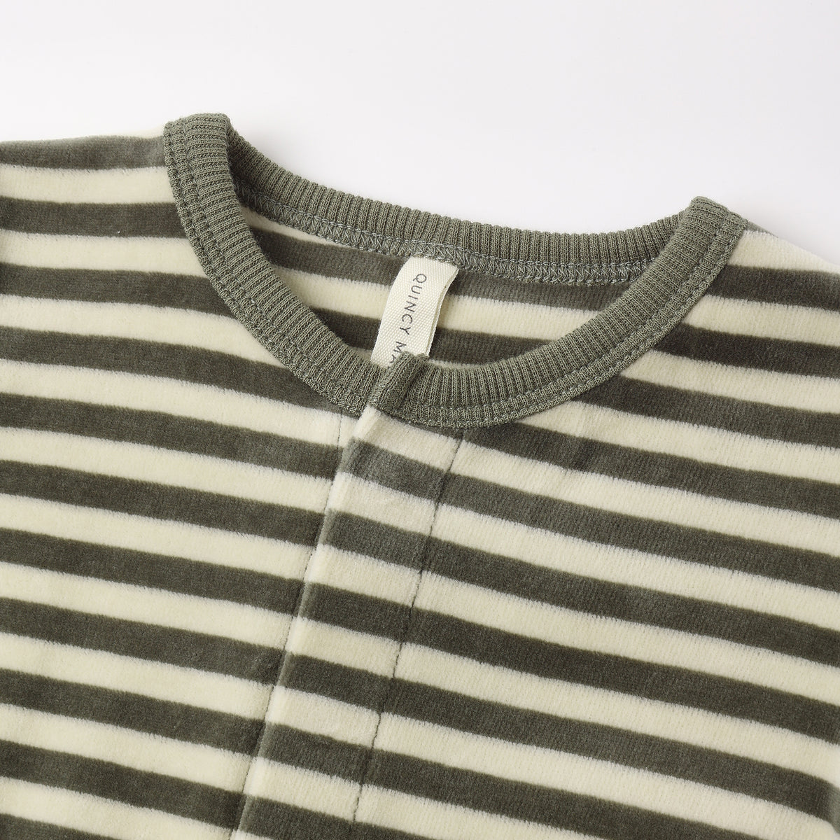 Close-up view of the neckline and collar of a long-sleeve baby footie featuring a green and white horizontal stripe pattern with a solid green ribbed collar and a small brand tag inside.