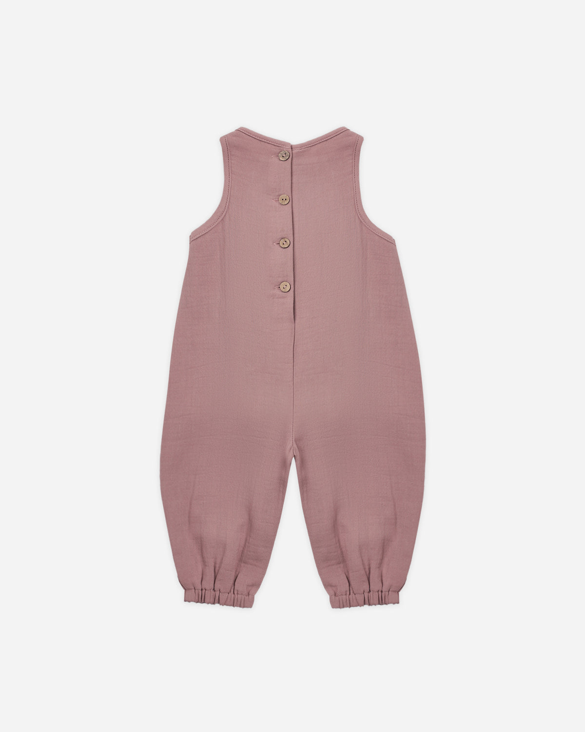 A sleeveless dusty rose baby jumpsuit with a button-up back, photographed flat against a light gray background.