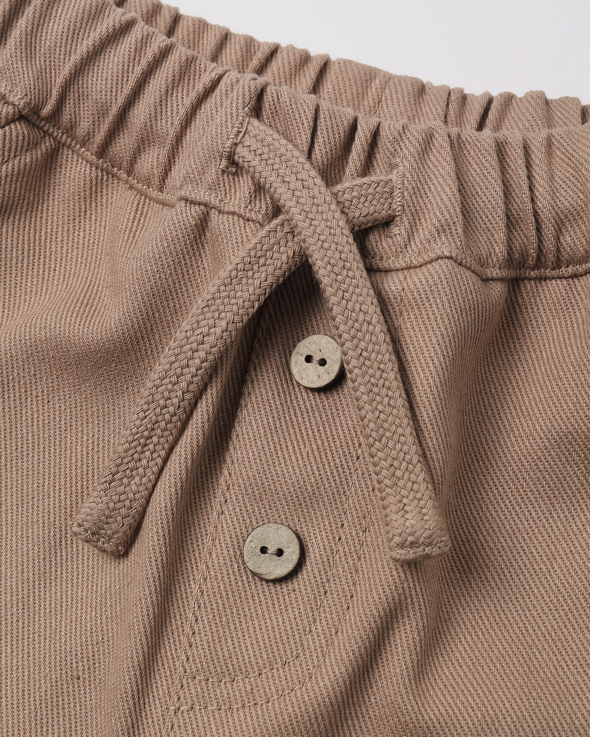 Dusty taupe-brown color with two decorative buttons.