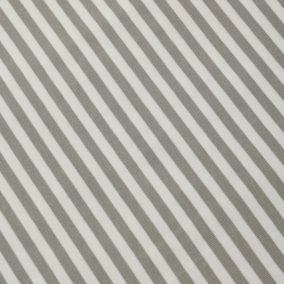 Close-up of a striped fabric pattern with alternating warm taupe-gray and off-white diagonal stripes.