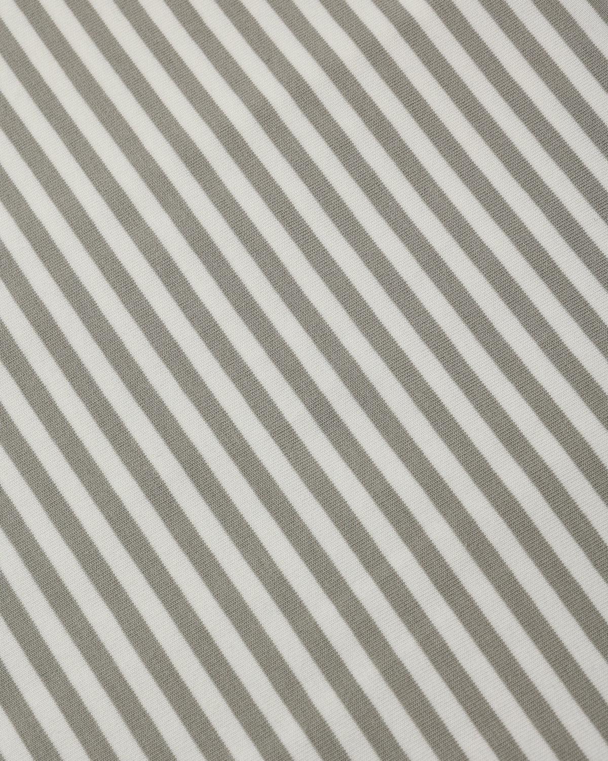 Close-up of a striped fabric pattern with alternating warm taupe-gray and off-white diagonal stripes.