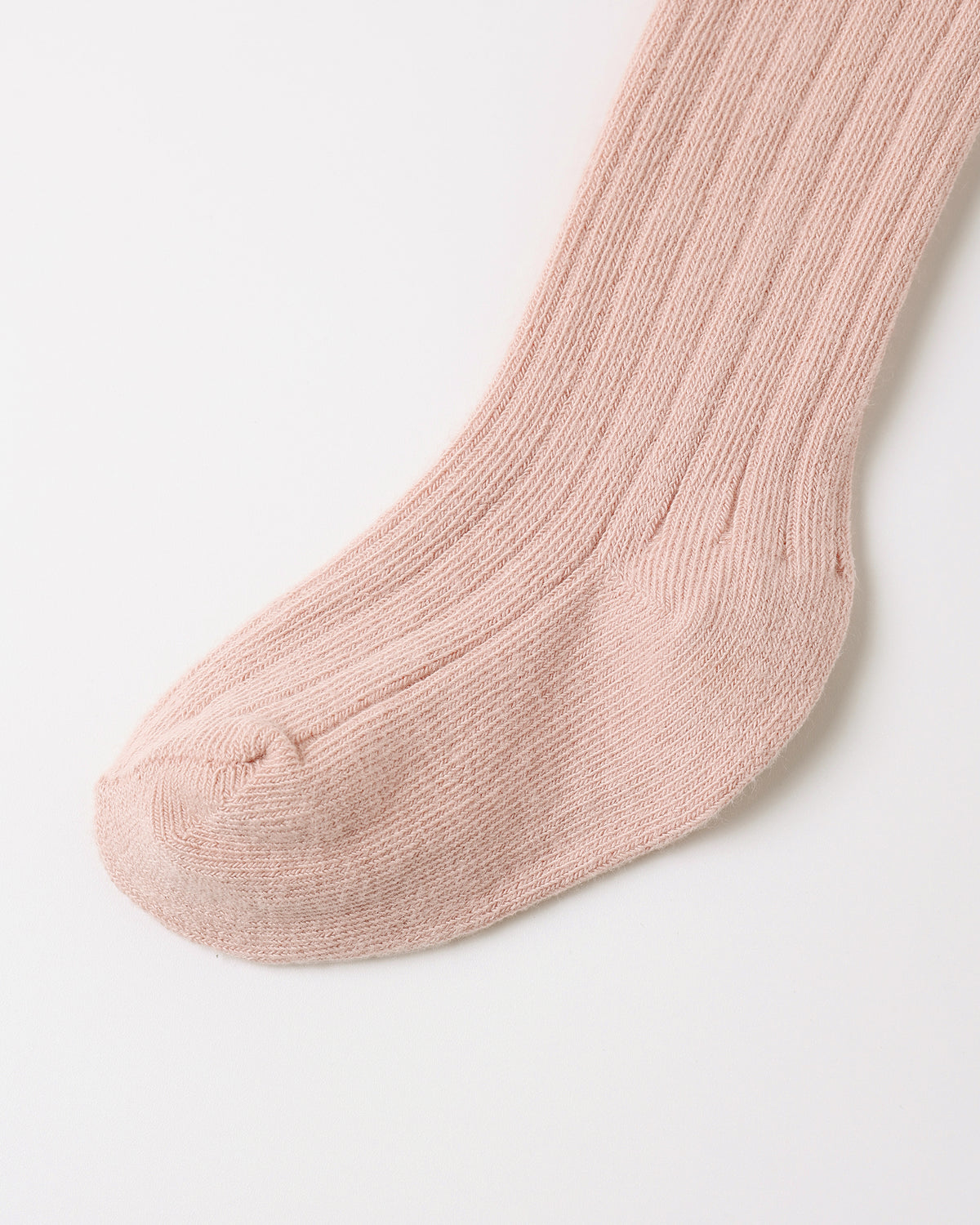 A single ribbed knit sock in a soft dusty pink color, shown against a clean white background.