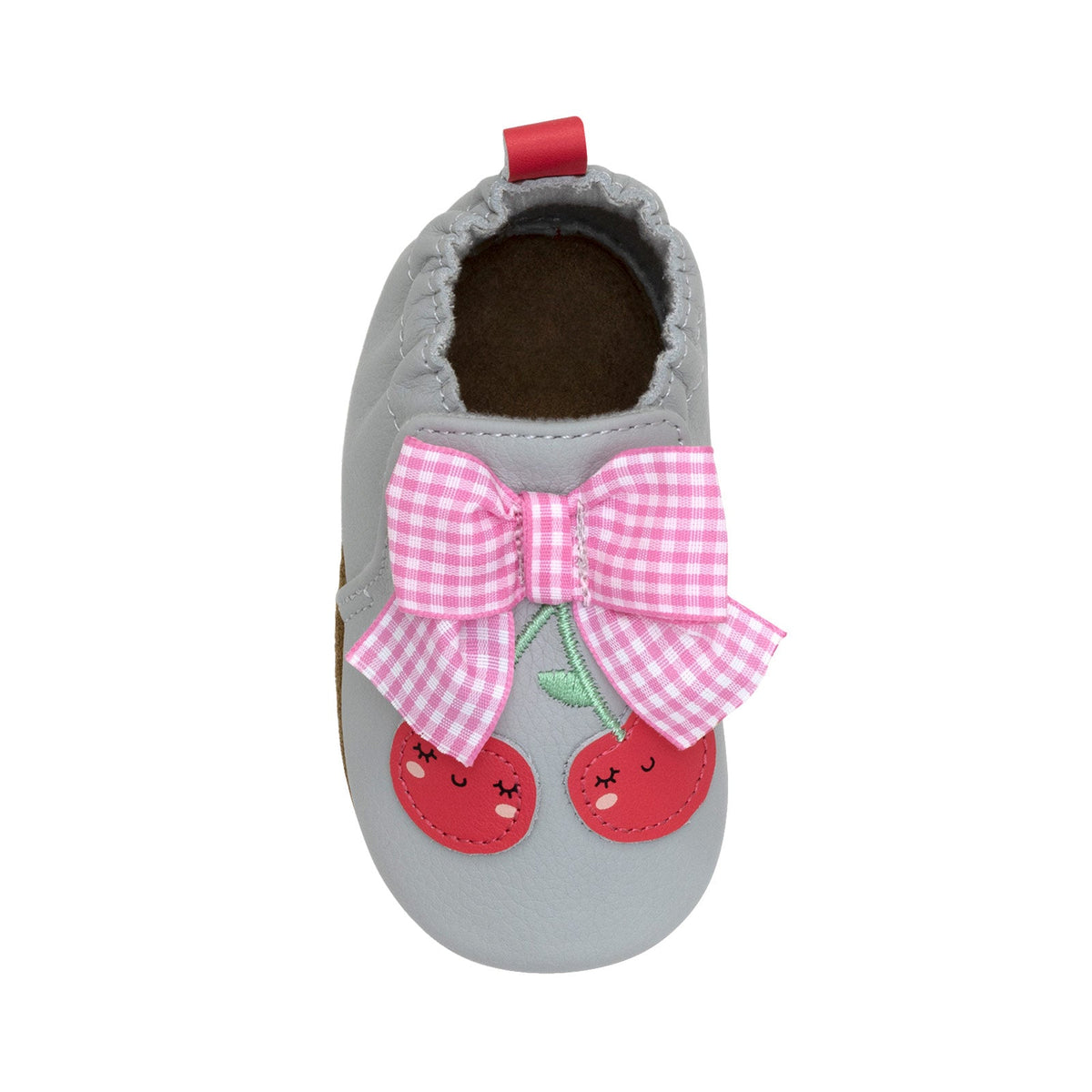 Gray baby shoe with pink bow and cherry design on a white background