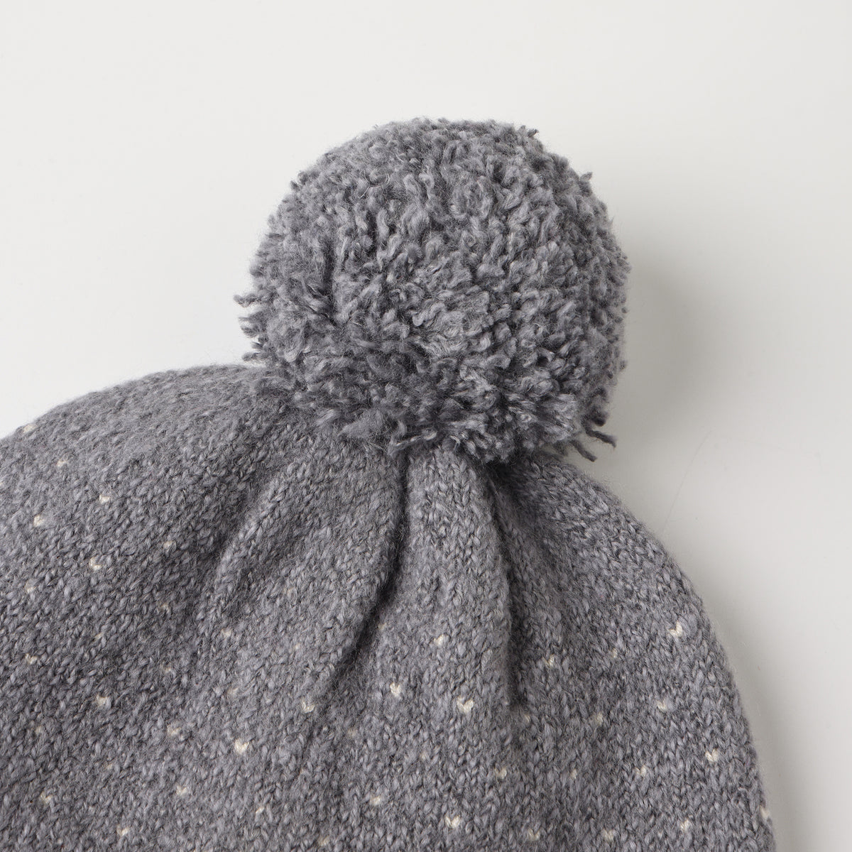 The selected item is a light blue knitted beanie hat with a ribbed cuff and a matching pom-pom on top on a white background.