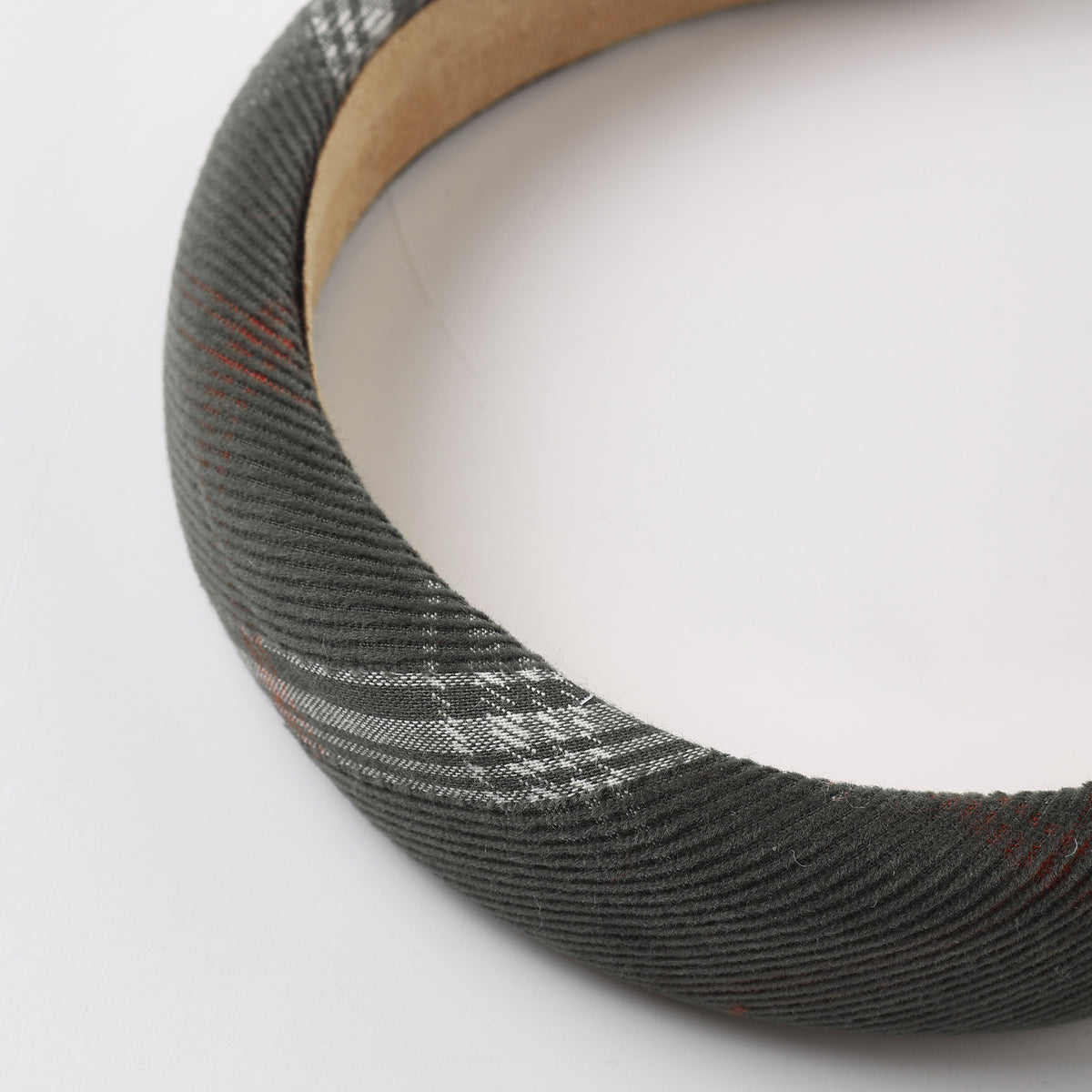 A fabric headband with a gray and white check or plaid pattern.