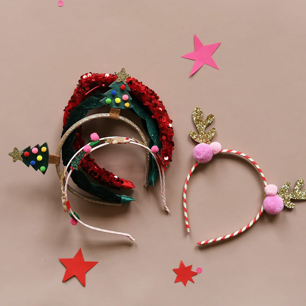Decorative headbands with festive designs on a beige background with stars.