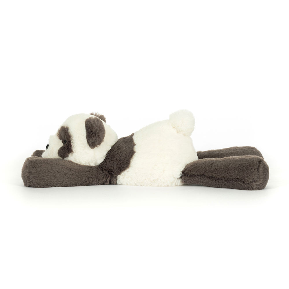Plush panda toy lying on a white background