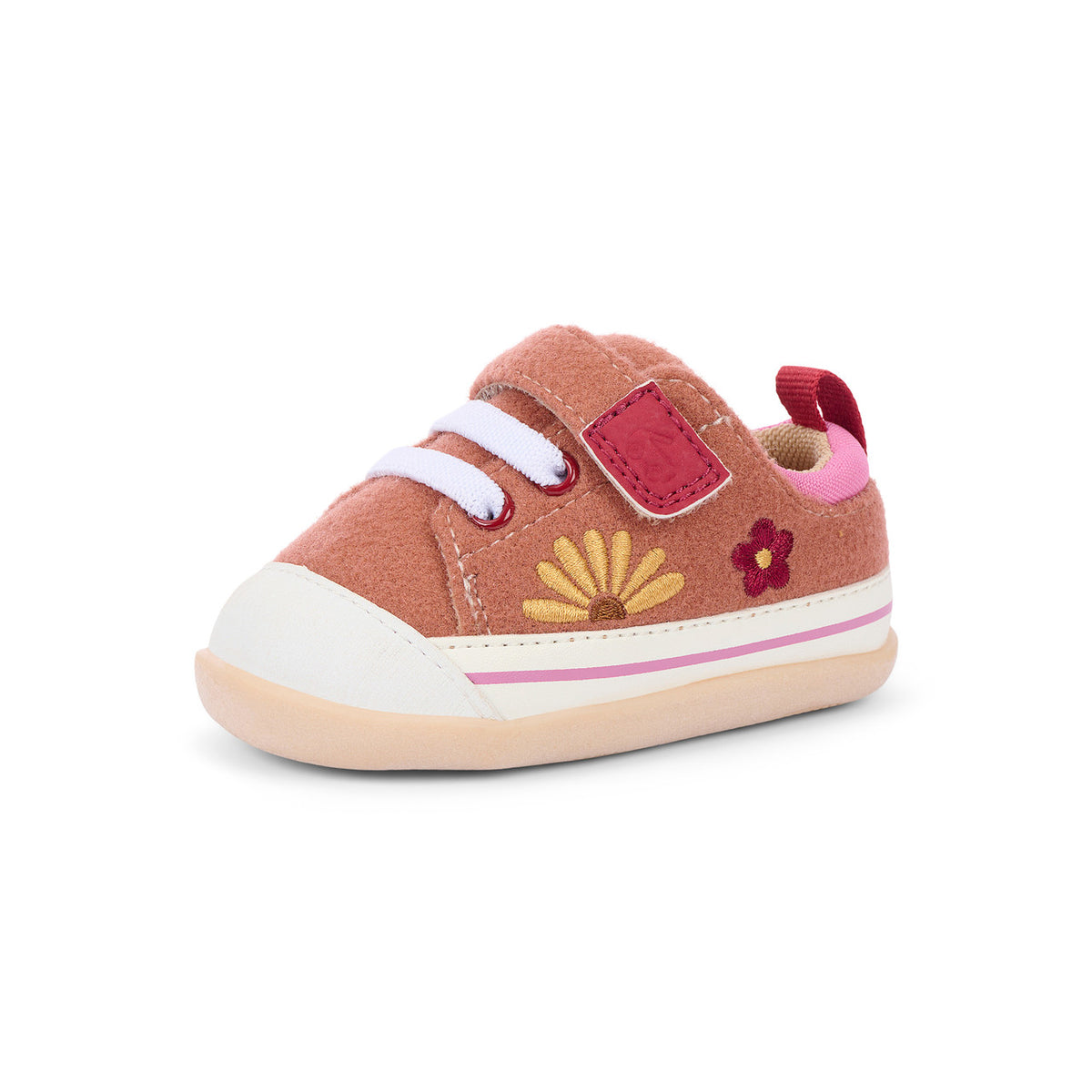 A toddler's canvas sneaker in a dusty rose pink color, featuring a white rubber toe cap, white laces, embroidered yellow and pink flowers, and a pink pull tab, shown against a plain white background.