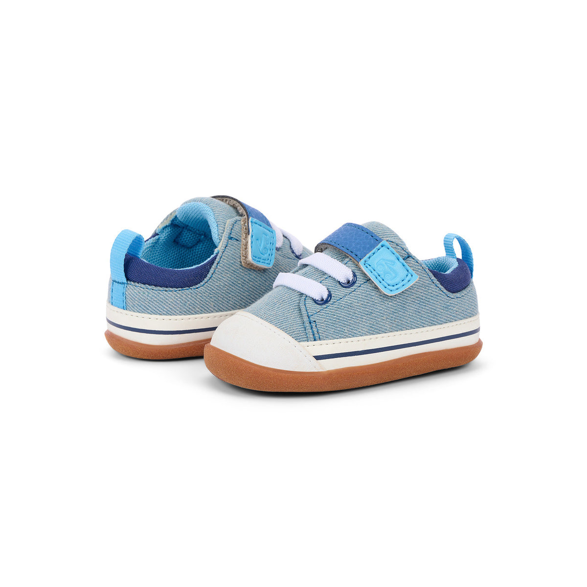A pair of toddler canvas sneakers in light blue and navy blue, featuring white laces, white rubber toe caps, and brown gum soles, photographed on a clean white background.