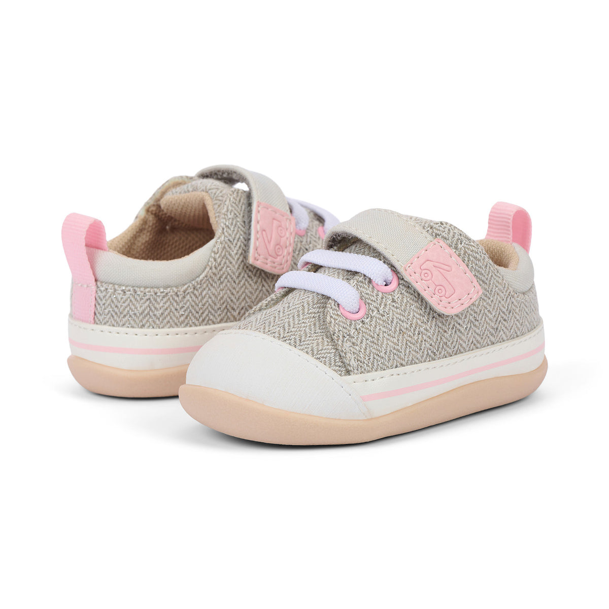 Pair of children's sneakers with pink accents on a white background