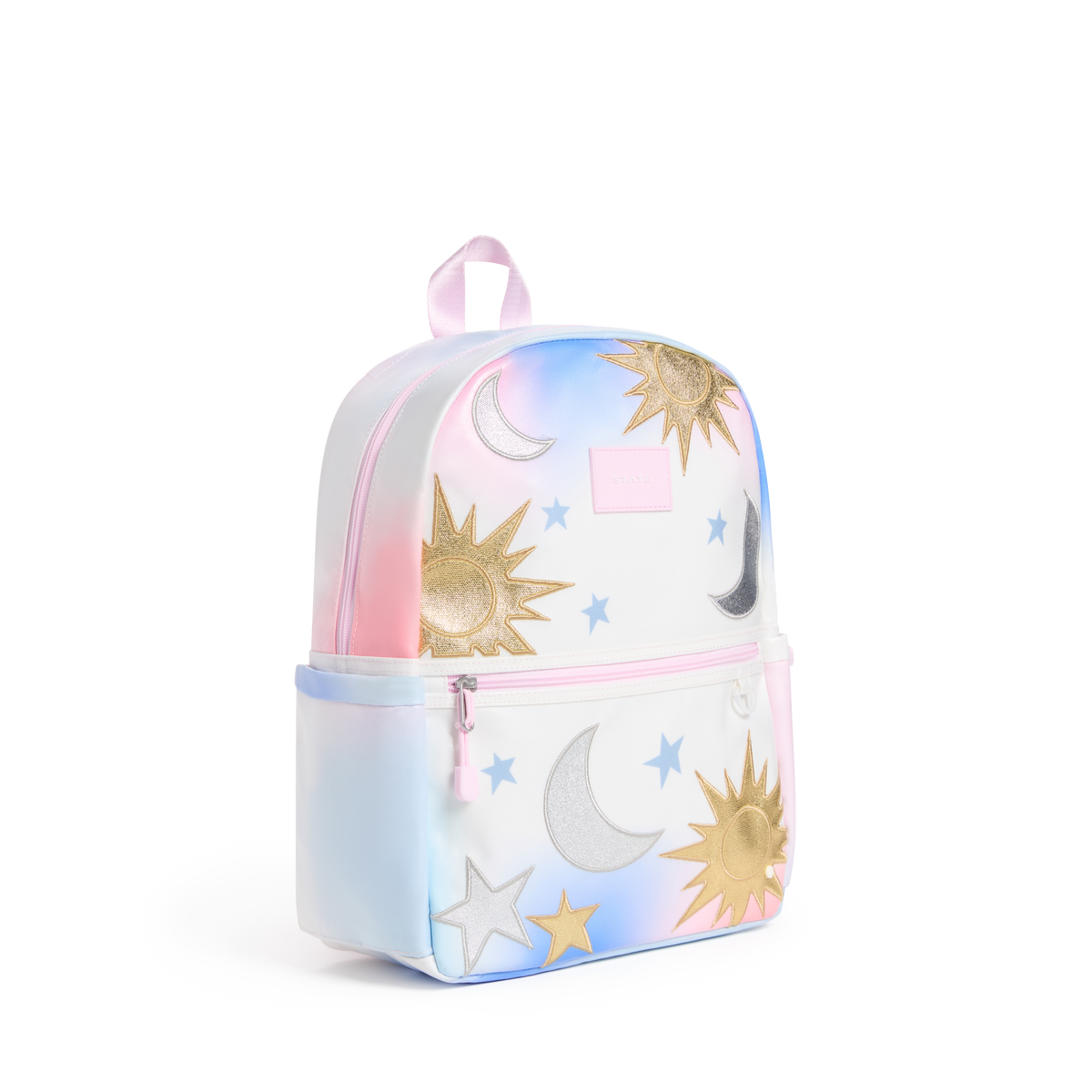 A small iridescent pastel backpack with a celestial print featuring gold suns, silver and white crescent moons, and blue stars, shown on a plain white background.