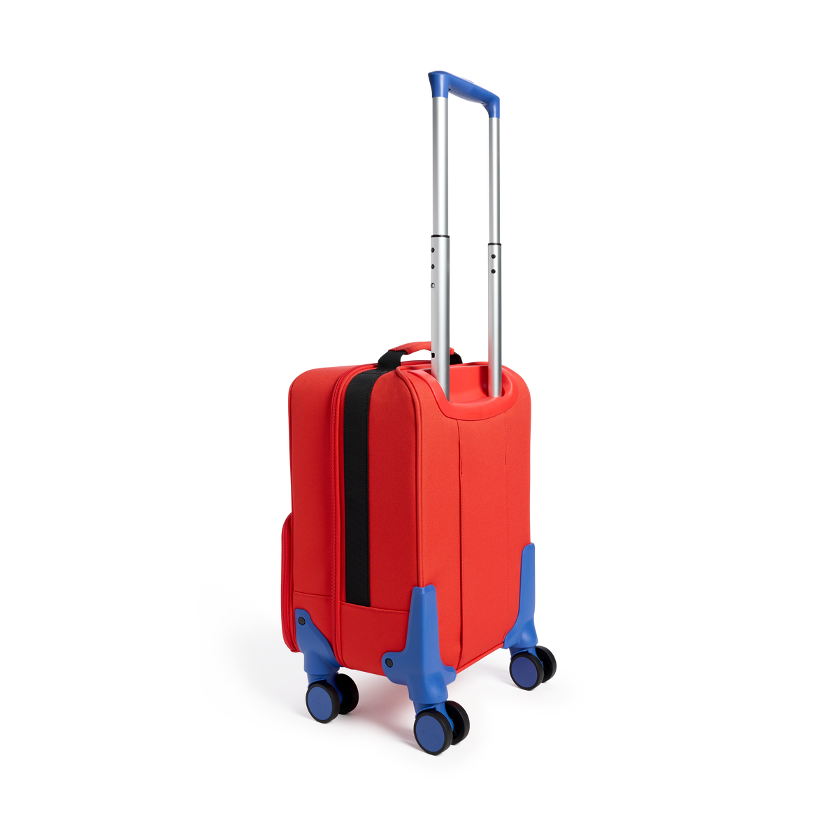 Rear three-quarters view of a red State Bags Mini Logan carry-on suitcase designed to look like a firetruck, showcasing its blue telescopic handle, 360-degree spinner wheels, and black zipper and side pocket details against a transparent background.