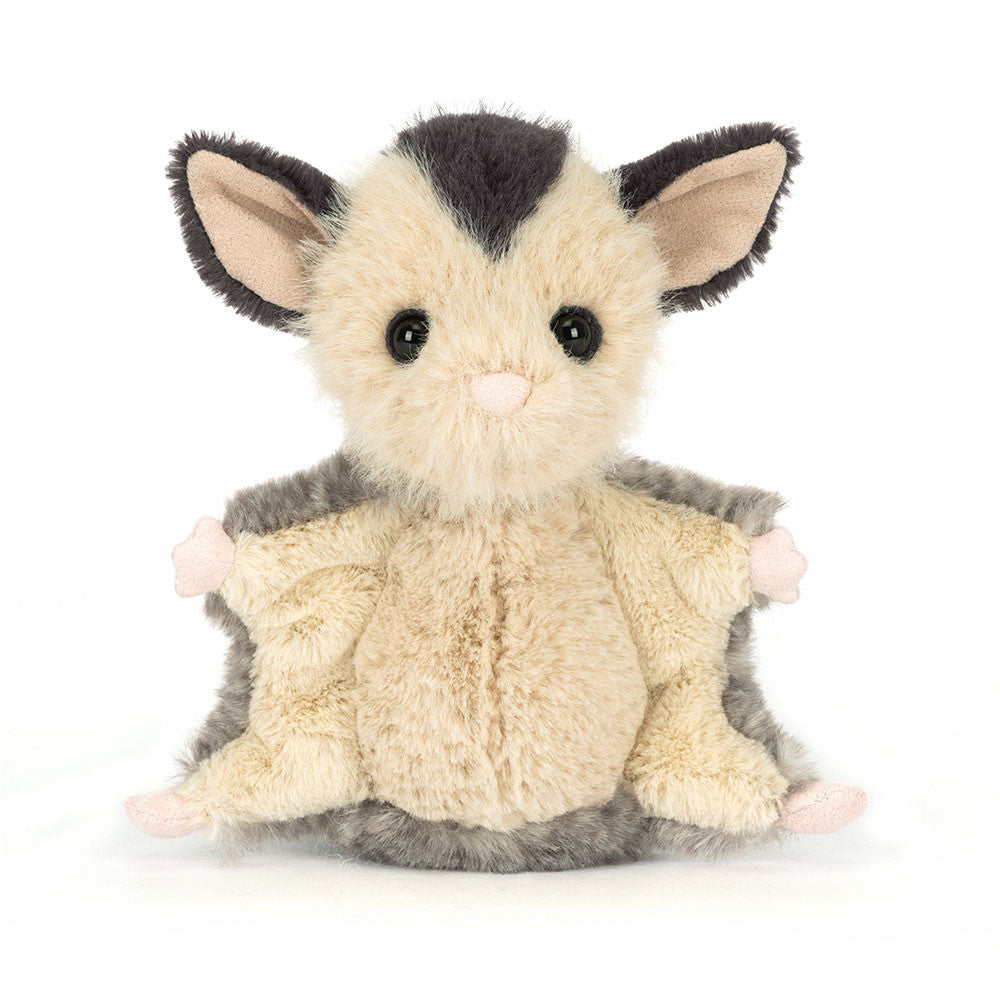 Plush toy possum with black hair on head on a white background