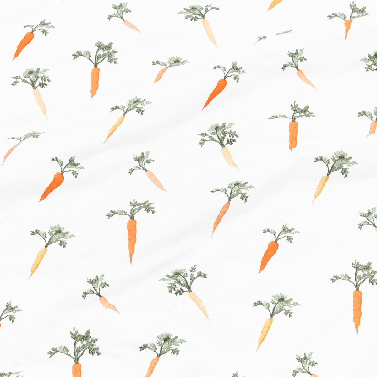 Pattern of orange carrots with green tops on a white background