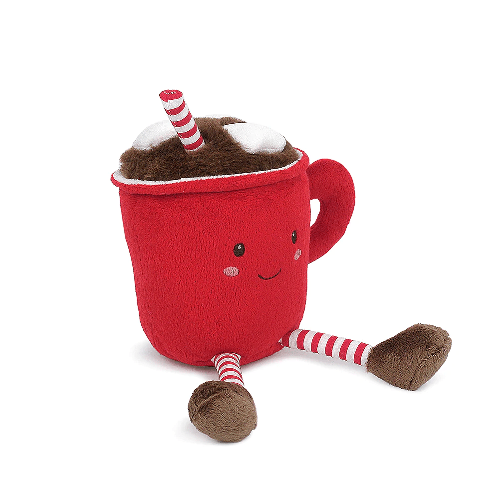 A red plush hot cocoa mug toy with a smiling face, white whipped cream on top, brown cocoa inside, and striped red-and-white legs and straw, photographed on a clean white background.