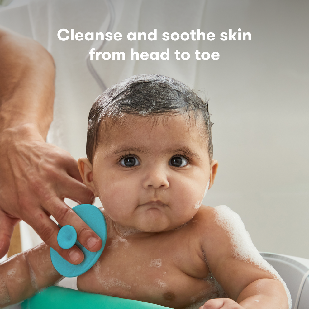 Baby being bathed with a blue washcloth, text 'Cleanse and soothe skin from head to toe' above.