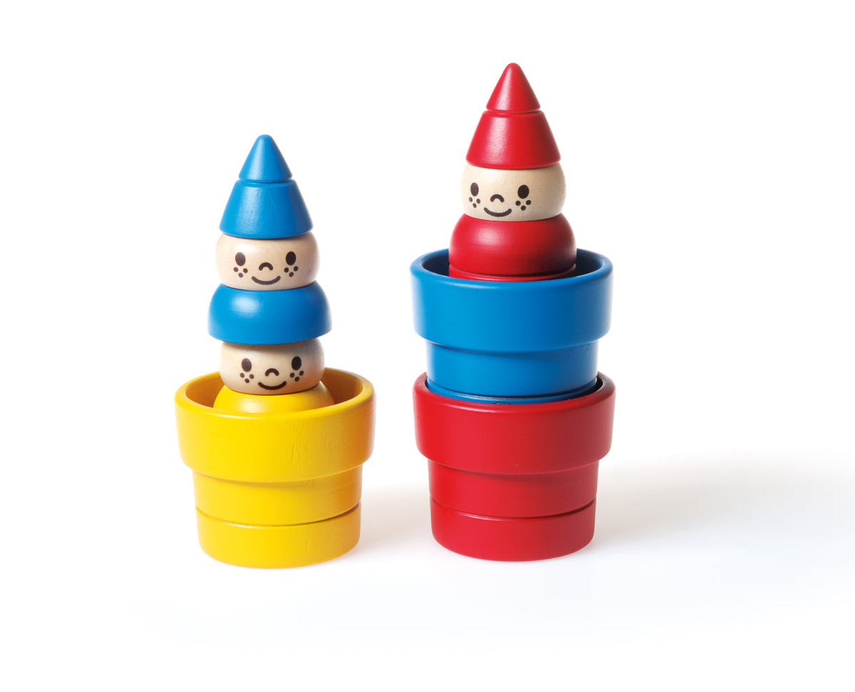 Stackable wooden toys with colorful hats and bodies on a white background